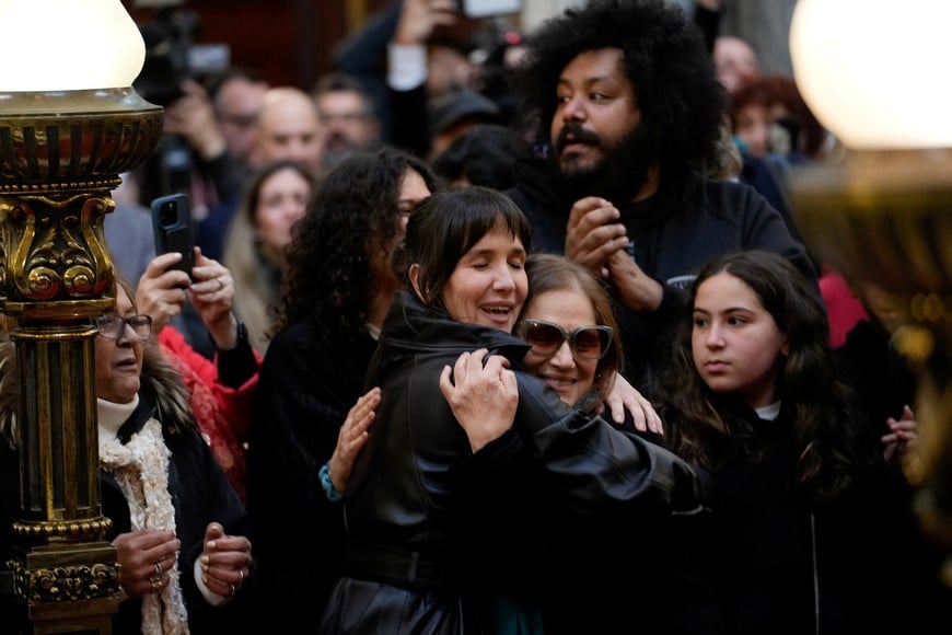 Actress Natalia Oreiro embraces Patricia Jodara, wife of late Uruguayan musician Ruben Rada, during Rada's funeral service at the Legislative Palace, in Montevideo, Uruguay, August 27, 2026. REUTERS/Andres Cuenca