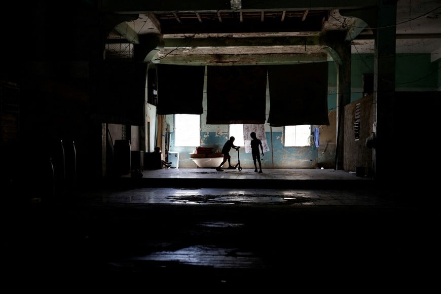Children play inside their home during a nationwide blackout after Cuba's national power grid collapsed, marking the third major outage in nine days, in Havana, Cuba, July 14, 2026. REUTERS/Norlys Perez TPX IMAGES OF THE DAY