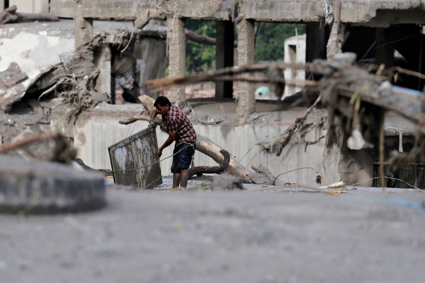 A man salvages his belongings from mud following devastating floods, in Trishuli in Nuwakot district, Nepal, August 27, 2026. REUTERS/Navesh Chitrakar