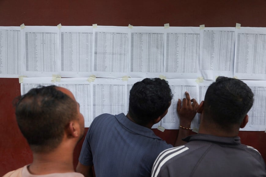 People look at the lists of survivors outside Maithili Barrack army training centre, in the aftermath of flash floods and mudslide, in Nuwakot Nepal, August 28, 2026. REUTERS/Francis Mascarenhas