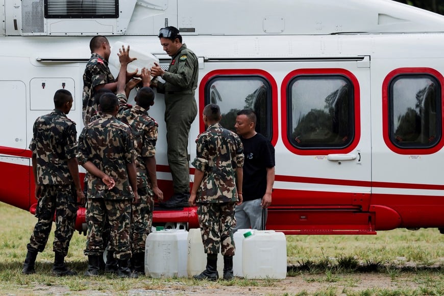 Members of Nepal army refuel a helicopter used in ferrying people affected by deadly flash floods and mudslides at Maithali Barrack, an army training centre, in Trishuli, Nuwakot district, Nepal, August 28, 2026. REUTERS/Navesh Chitrakar