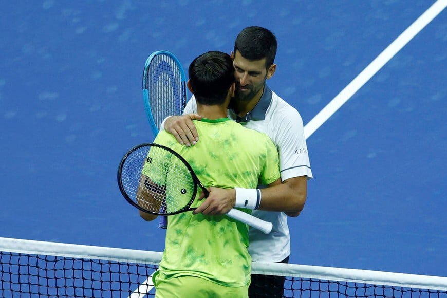 Tennis - U.S. Open - Flushing Meadows, New York, United States - August 30, 2026
Serbia's Novak Djokovic hugs Argentina's Mariano Navone after losing his first round match REUTERS/Jeenah Moon