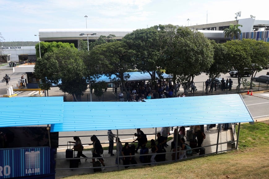 Passengers line up outside a temporary counter set up in a tent as commercial flights resume at Simon Bolivar International Airport after it was damaged by the June 24 earthquakes, in Maiquetia, Venezuela, September 1, 2026. REUTERS/Leonardo Fernandez Viloria