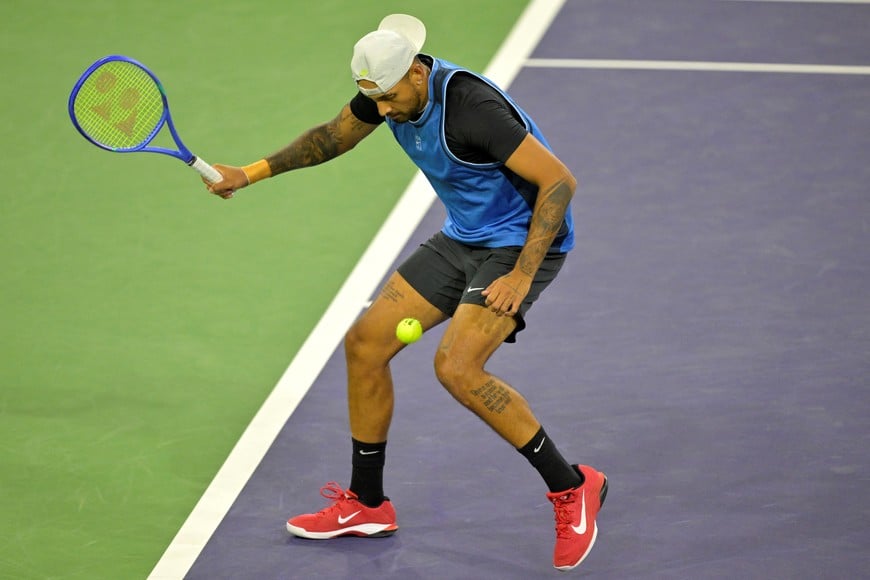 Mar 6, 2025; Indian Wells, CA, USA; Nick Kyrgios (AUS) hits a shot between his legs against Botic Van De Zandschulp (not pictured) during his first round match of the BNP Paribas Open at the Indian Well Tennis Garden. Mandatory Credit: Jayne Kamin-Oncea-Imagn Images