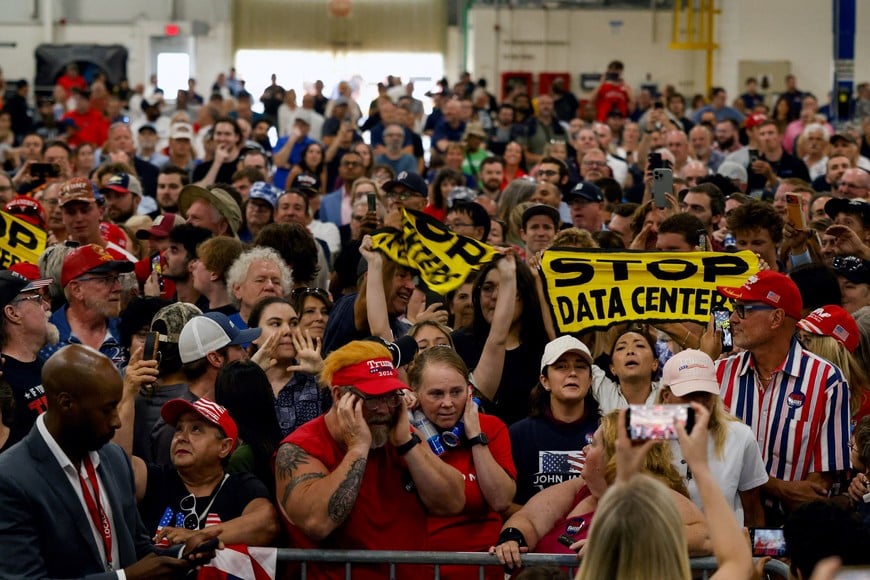 Protestors hold up 'Stop data centers' signs, on the day of U.S. President Donald Trump's speech at the General Motors Proving Ground, in Milford, Michigan, U.S. July 27, 2026. REUTERS/Carlos Osorio TPX IMAGES OF THE DAY