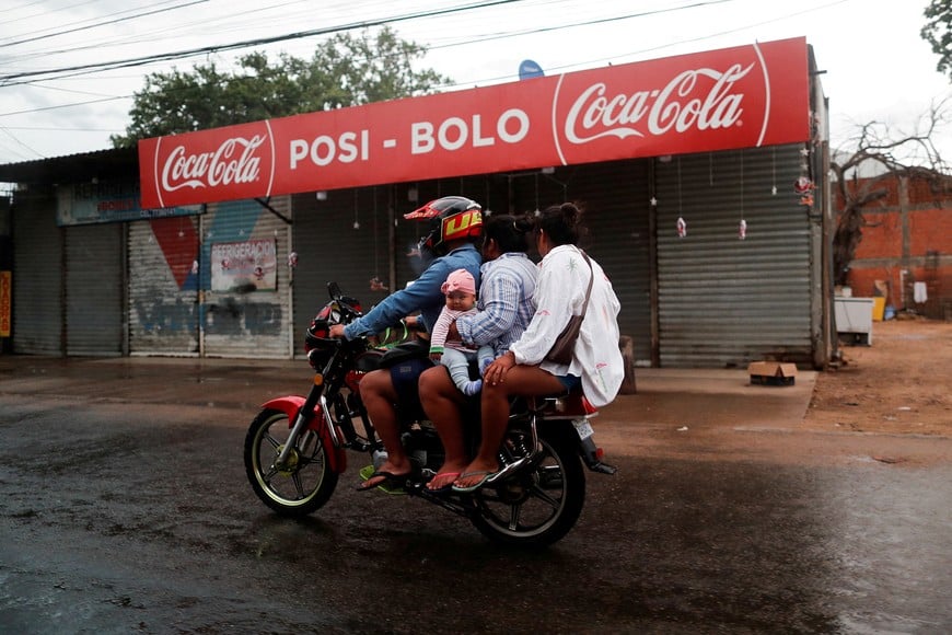 FILE PHOTO: People ride on a motorcycle in Santa Cruz de la Sierra, Bolivia, January 2, 2023. REUTERS/Agustin Marcarian/File Photo