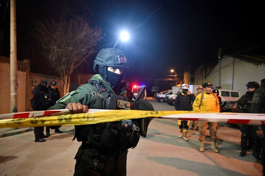 A police officer holds a caution tape after explosions that left people dead and injured at the "Bolivar" Mechanized Artillery Regiment, in Viacha, Bolivia, September 4, 2026. REUTERS/Claudia Morales