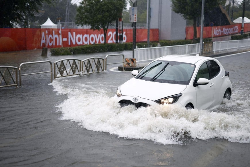 A car drives along a road flooded by heavy rain while banners for the Aichi-Nagoya Asian Games are visible in the background in Nagoya, central Japan September 8, 2026, in this photo taken by Kyodo. Mandatory credit Kyodo/via REUTERS ATTENTION EDITORS - THIS IMAGE HAS BEEN SUPPLIED BY A THIRD PARTY. MANDATORY CREDIT. JAPAN OUT. NO COMMERCIAL OR EDITORIAL SALES IN JAPAN.