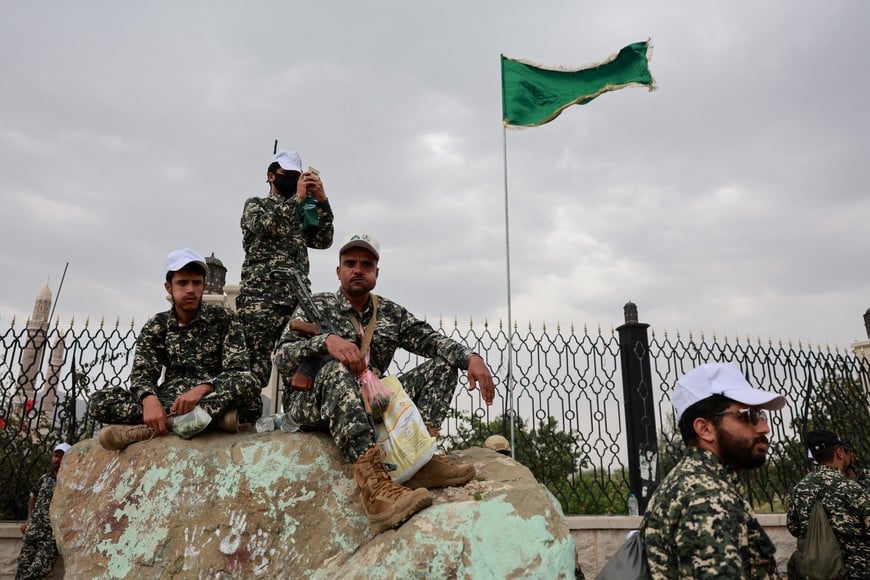 Members of Houthi security forces sit on a rock at the site of a rally held to commemorate Mawlid, marking the anniversary of Prophet Muhammad's birthday, in Sanaa, Yemen, August 25, 2026. REUTERS/Khaled Abdullah TPX IMAGES OF THE DAY
