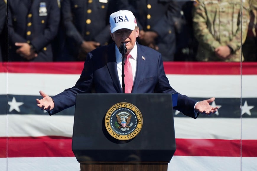 U.S. President Donald Trump speaks, while standing behind protective glass, during the Steel Across America event featuring a 21-foot steel beam recovered from the World Trade Centre South Tower, on the Ellipse near the White House in Washington, D.C., U.S., September 8, 2026. REUTERS/Nathan Howard