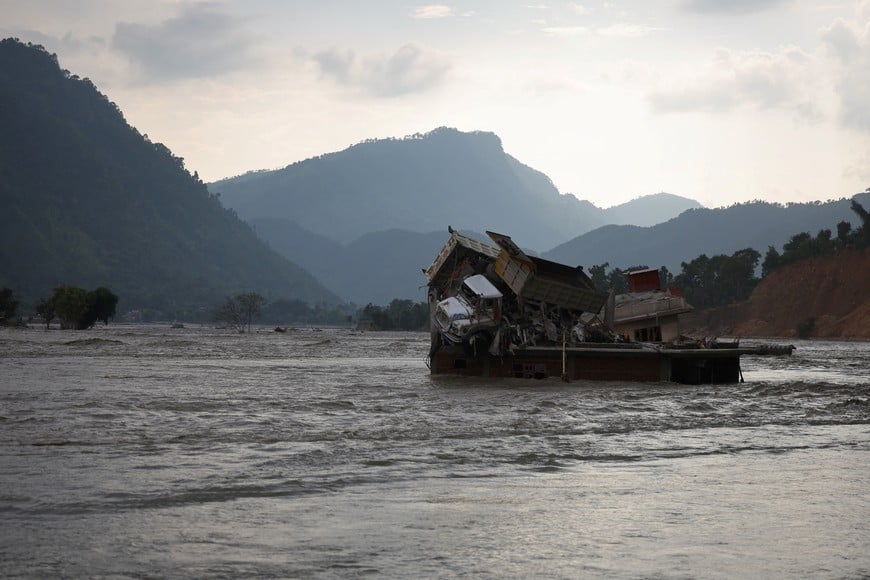 A flooded home, with damaged trucks on its roof, along the banks of the Trishuli River, following the deadly flash floods and mudslides in Nuwakot district, Bagmati province, Nepal, September 8, 2026. REUTERS/Anushree Fadnavis
