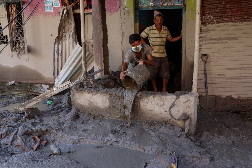 A resident pours out mud from a house following deadly flash floods and a mudslide, in Devighat, Nuwakot district, Nepal, September 9, 2026. REUTERS/Tyrone Siu
