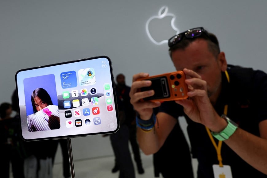 A man records images of the new foldable iPhone Duo on display during Apple's event at the Steve Jobs Theater in Cupertino, California, U.S. September 9, 2026. REUTERS/Carlos Barria