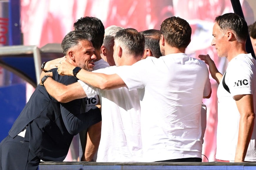 Soccer Football - Bundesliga - RB Leipzig v Borussia Moenchengladbach - Red Bull Arena, Leipzig, Germany - August 29, 2026
RB Leipzig coach Martin Demichelis celebrates with staff members after Ridle Baku scored their first goal REUTERS/Annegret Hilse DFL REGULATIONS PROHIBIT ANY USE OF PHOTOGRAPHS AS IMAGE SEQUENCES AND/OR QUASI-VIDEO.