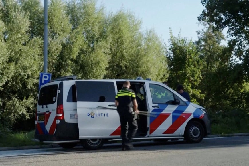 A police officer carries away objects after suspected sabotage disrupted Dutch train services, at an unknown location in the Netherlands, in this screengrab taken from a video released on September 15, 2026. Video obtained by Reuters/Handout via REUTERS THIS IMAGE HAS BEEN SUPPLIED BY A THIRD PARTY. NO USE NETHERLANDS.