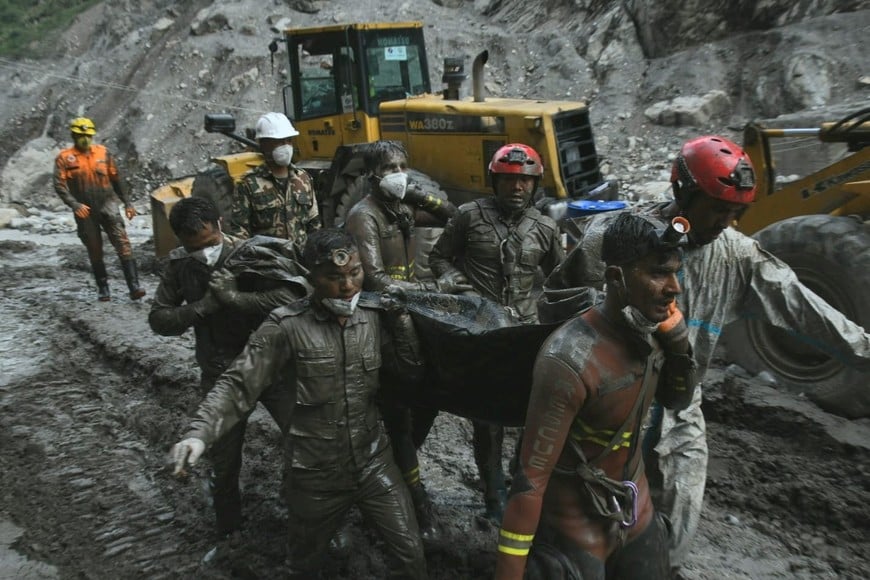 Members of a search and rescue teams carry the body of a victim from the inside the Chilime Hydropower Project tunnel, following deadly flash floods and mudslides hit parts of Nepal, in this handout obtained by Reuters on September 16, 2026. Nepal Army/Handout via REUTERS THIS IMAGE HAS BEEN SUPPLIED BY A THIRD PARTY. MANDATORY CREDIT. NO RESALES. NO ARCHIVES.