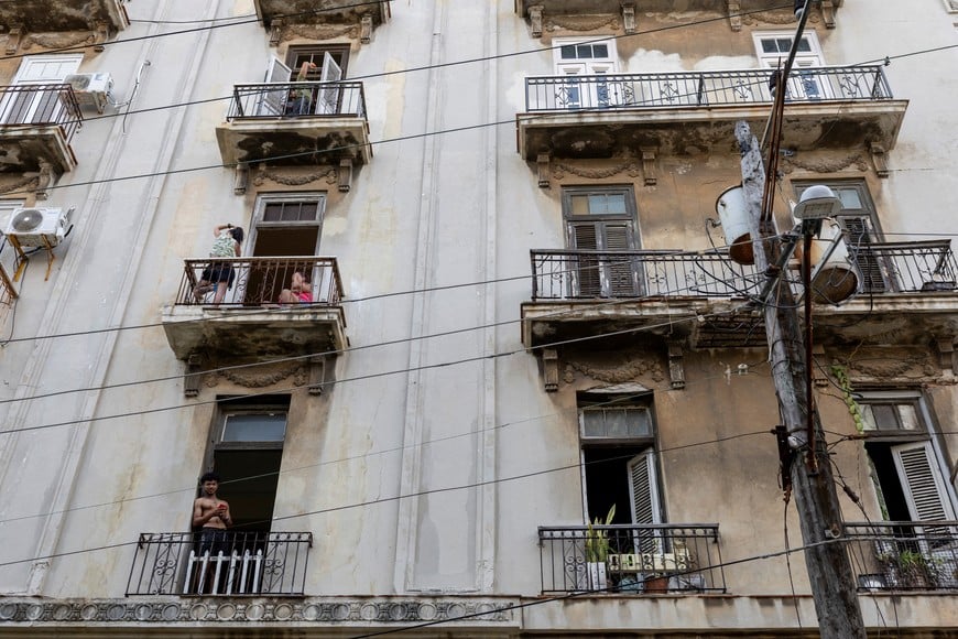 Residents gather on balconies and by open windows during a power outage in Havana, Cuba, September 18, 2026. REUTERS/Ricardo Arduengo