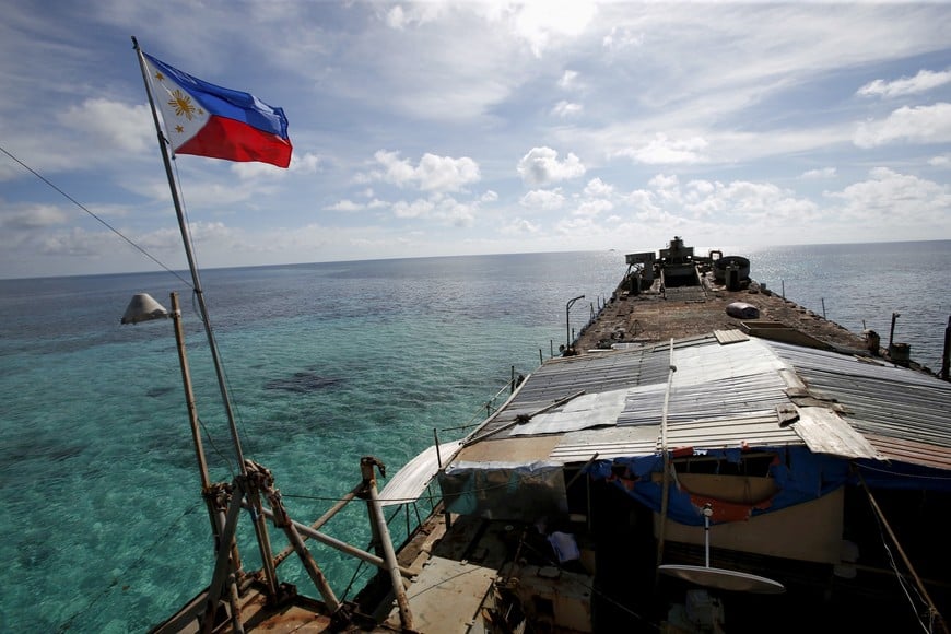 FILE PHOTO: A Philippine flag flutters from BRP Sierra Madre, a dilapidated Philippine Navy ship that has been aground since 1999 and became a Philippine military detachment on the disputed Second Thomas Shoal, part of the Spratly Islands, in the South China Sea March 29, 2014. REUTERS/Erik De Castro/File Photo TPX IMAGES OF THE DAY/File Photo