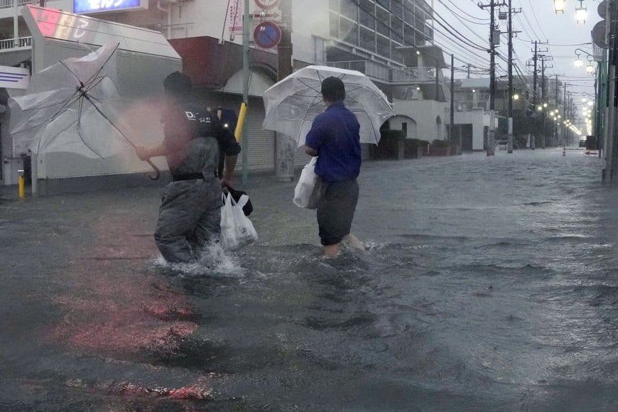 People wade through a flooded street as Typhoon Dujuan brings heavy rain, in Ichikawa, Chiba Prefecture, Japan, September 21, 2026 in this photo taken by Kyodo. Kyodo/via REUTERS ATTENTION EDITORS - THIS IMAGE HAS BEEN SUPPLIED BY A THIRD PARTY. MANDATORY CREDIT. JAPAN OUT. NO COMMERCIAL OR EDITORIAL SALES IN JAPAN.
