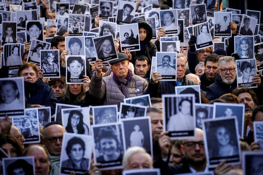 People hold images of the victims of the 1994 bombing attack on the Argentine Israelite Mutual Association (AMIA) community centre, marking the 31st anniversary of the attack, in Buenos Aires, Argentina July 18, 2025. REUTERS/Mariana Nedelcu TPX IMAGES OF THE DAY