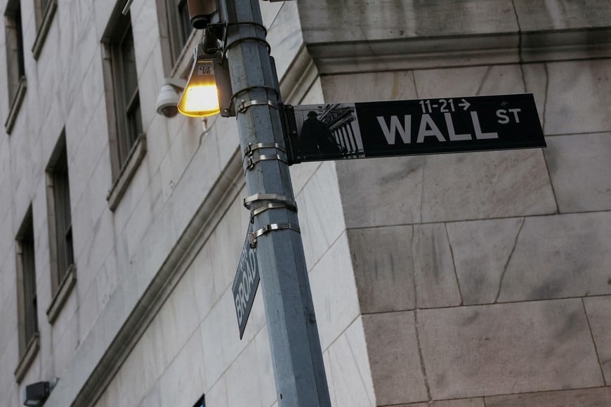 FILE PHOTO: The Wall street sign hangs outside the New York Stock Exchange (NYSE) building on Tuesday following Monday’s broad sell off in New York City, U.S., March 11, 2025. REUTERS/Shannon Stapleton/File Photo