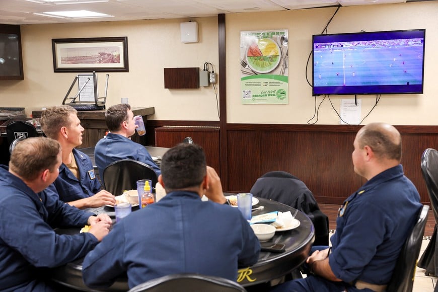 Sailors aboard the USS Theodore Roosevelt watch a FIFA World Cup match as the aircraft carrier takes part in the Rim of the Pacific (RIMPAC) military exercises in waters south of the Hawaiian Islands, U.S., July 11, 2026. REUTERS/Marco Garcia