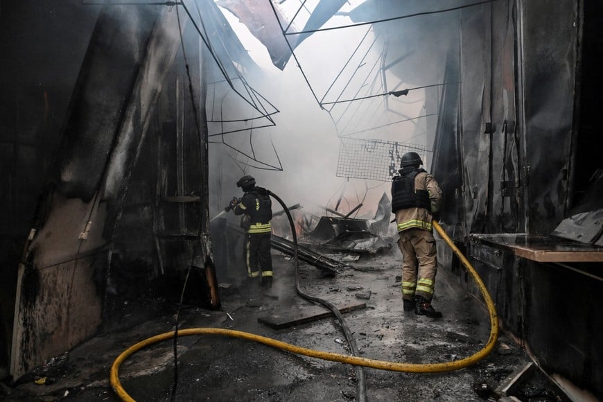Firefighters work at the site of a damaged market hit during a Russian drone strike, amid Russia's attack on Ukraine, in Zaporizhzhia, Ukraine September 26, 2026. REUTERS/Stringer