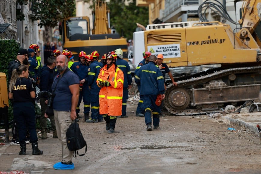 Emergency personnel work near excavators during a search and rescue operation after a building partially collapsed following an explosion in the Plaka area, which is popular with tourists, in central Athens, Greece, September 26, 2026. REUTERS/Stelios Misinas