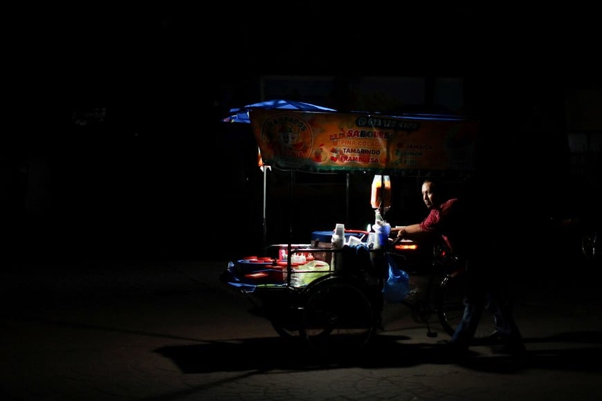 A food vendor walks on a street as Hurricane Polo approaches Baja California Sur, in Loreto, Mexico, September 27, 2026. REUTERS/Raquel Cunha