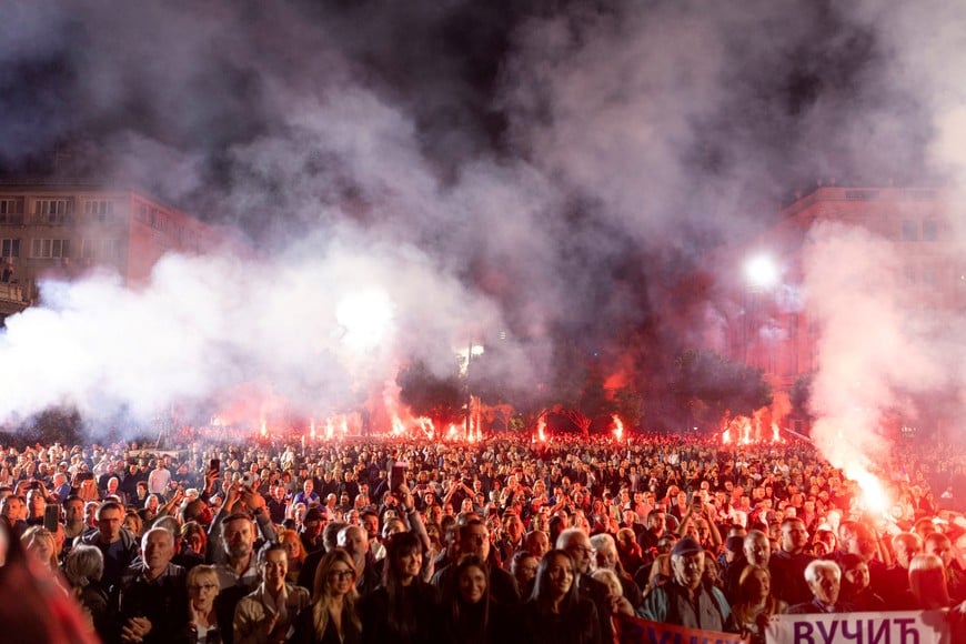 Supporters of Serbian President Aleksandar Vucic light flares outside the Presidency of Serbia moments before he formally submits his resignation, ending his second and final five-year term in office, in Belgrade, Serbia, September 27, 2026. REUTERS/Djordje Kojadinovic