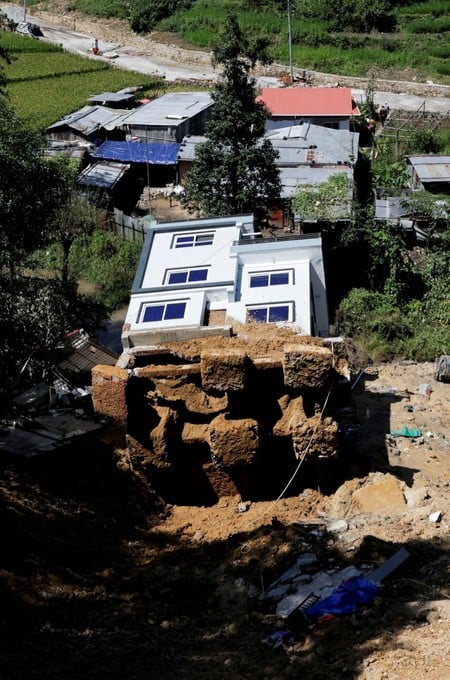 A toppled house after it was swept by a landslide, following incessant rains, in Lalitpur, Nepal, September 28, 2026. REUTERS/Navesh Chitrakar