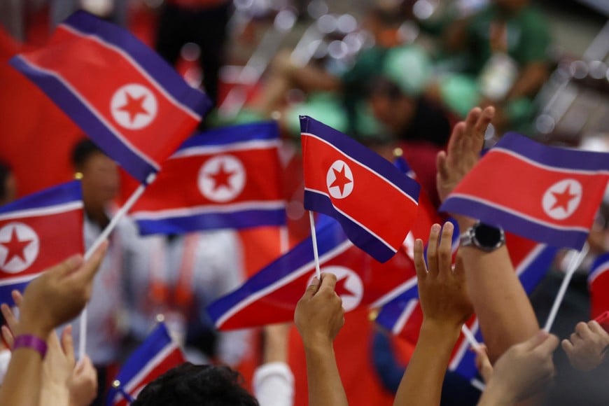 Asian Games - Aichi-Nagoya 2026 - Weightlifting - Nagoya City Trade and Industry Center, Nagoya, Japan - September 28, 2026
Fans wave North Korea flag after Kwang Ryol Ro won gold medal and made a new world record in clean and jerk during Men's 85kg Final REUTERS/Edgar Su