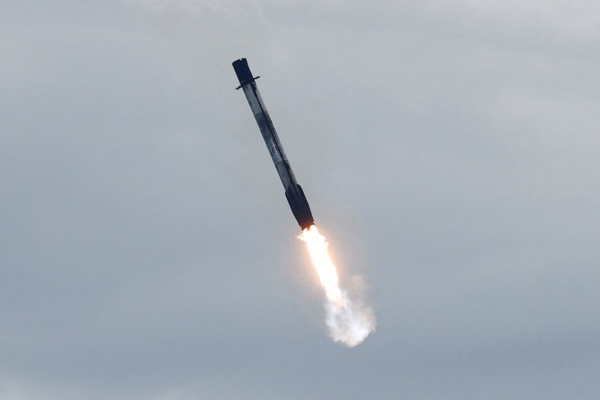 A SpaceX Falcon 9 booster returns to land after it and a Dragon spacecraft lift off on NASA's Crew-13 mission to the International Space Station, carrying NASA astronauts Jessica Watkins, Luke Delaney, Canadian Space Agency astronaut Joshua Kutryk and Russian cosmonaut Sergey Teteryatnikov at the Cape Canaveral Space Force Station in Cape Canaveral, Florida, U.S., October 1, 2026. REUTERS/Joe Skipper TPX IMAGES OF THE DAY