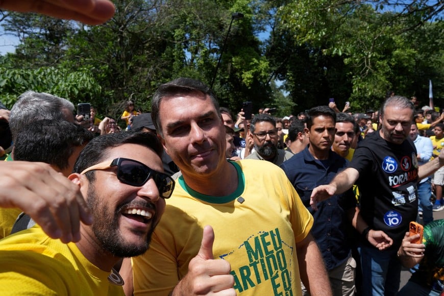 Brazilian presidential candidate Flavio Bolsonaro of the Liberal Party (PL) poses for a picture with a supporter during a campaign rally, one day before the general election, in Santa Barbara do Oeste, Brazil, October 3, 2026. REUTERS/Alexandre Meneghini