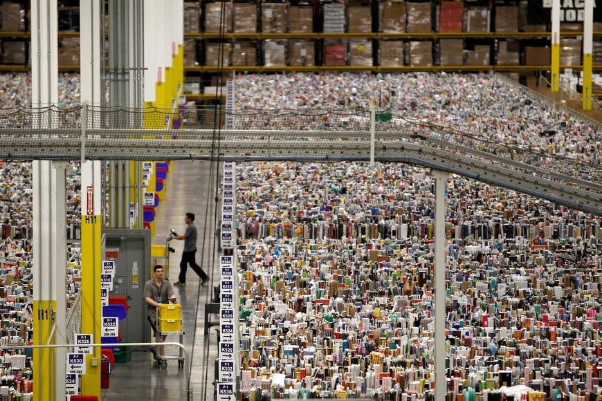 FILE PHOTO: Workers gather items for delivery from the warehouse floor at Amazon's distribution center in Phoenix, Arizona November 22, 2013. The web-based retailer is preparing for Cyber Monday, which is traditionally the busiest day of the year for online purchases, and falls on December 2 in 2013. REUTERS/Ralph D. Freso (UNITED STATES - Tags: BUSINESS EMPLOYMENT)/File Photo