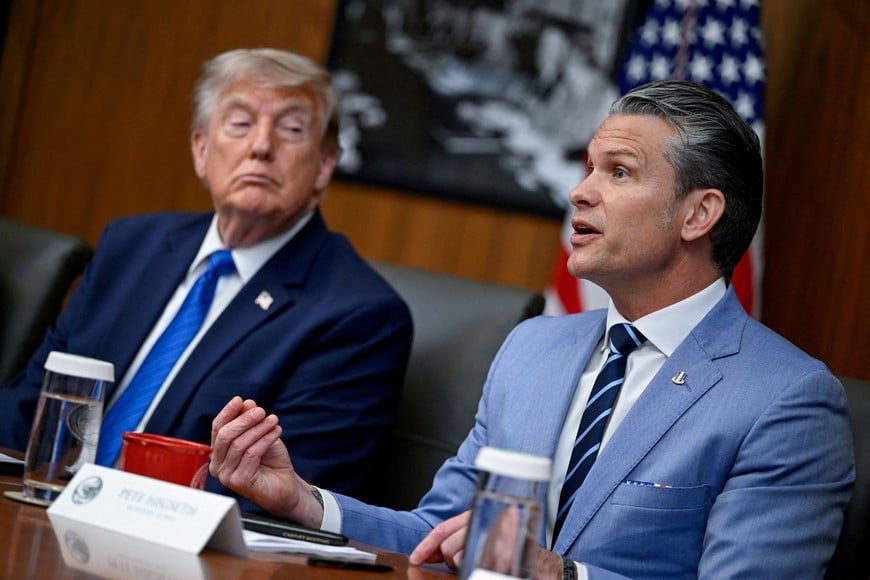 FILE PHOTO: U.S. President Donald Trump listens as Secretary of Defense Pete Hegseth speaks during a cabinet meeting at Camp David in Thurmont, Maryland, U.S., July 31, 2026. REUTERS/Daniel Heuer/File Photo