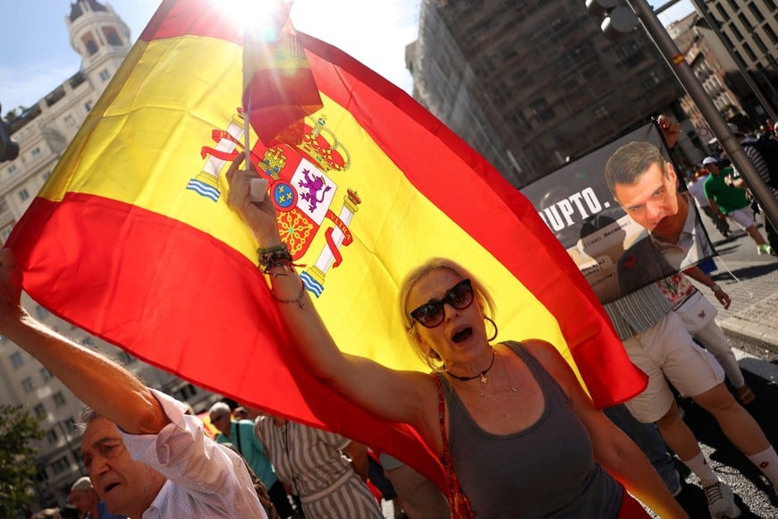 Protesters carry Spanish flags and banners depicting Spanish Prime Minister Pedro Sanchez next to the word “Corrupt”, as they take part in a march calling for general elections and to protest against the government's handling of Ceuta’s migrant crisis in Madrid, Spain, September 26, 2026. REUTERS/Susana Vera TPX IMAGES OF THE DAY