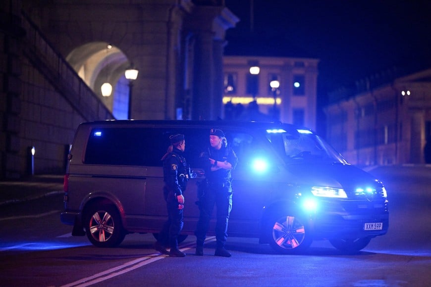 Policemen stand next to a car following reports of a man being shot by police, in central Stockholm, Sweden, October 6, 2026. TT News Agency/via REUTERS ATTENTION EDITORS - THIS IMAGE WAS PROVIDED BY A THIRD PARTY. SWEDEN OUT. NO COMMERCIAL OR EDITORIAL SALES IN SWEDEN. NO RESALES. NO ARCHIVES.