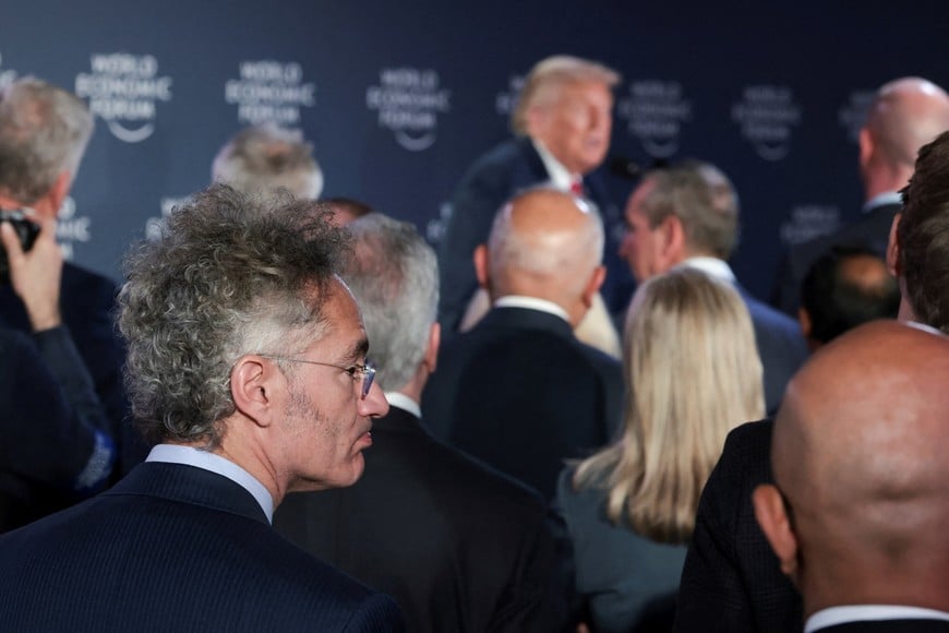 Palantir Technologies CEO Alex Karp listens as U.S. President Donald Trump speaks during a reception with business leaders, at the 56th annual World Economic Forum (WEF), in Davos, Switzerland, January 21, 2026. REUTERS/Jonathan Ernst