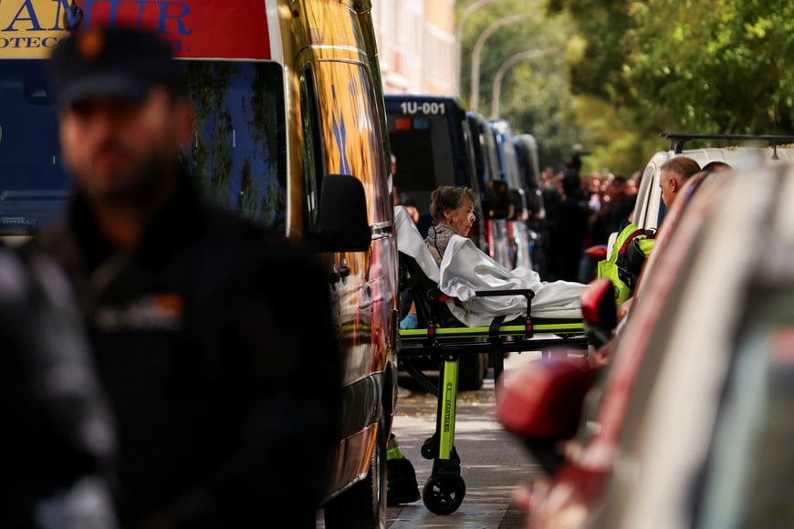 Maricarmen Abascal, 87, is transported on a stretcher to an ambulance, after she was evicted from the Madrid home where she had lived for more than seven decades after the apartment was acquired by an investment fund that sought a steep increase in her rent, despite efforts by housing activists to broker an alternative arrangement in Madrid, Spain, September 23, 2026. REUTERS/Susana Vera