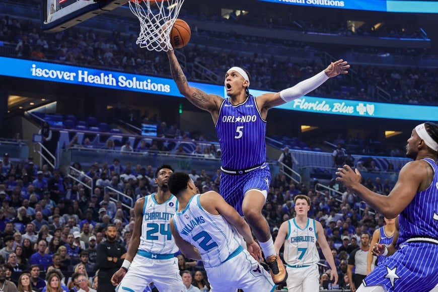 Apr 17, 2026; Orlando, Florida, USA; Charlotte Hornets forward Grant Williams (2) is fouled by Orlando Magic forward Paolo Banchero (5) during the second quarter during the play-in rounds of the 2026 NBA Playoffs at Kia Center. Mandatory Credit: Mike Watters-Imagn Images