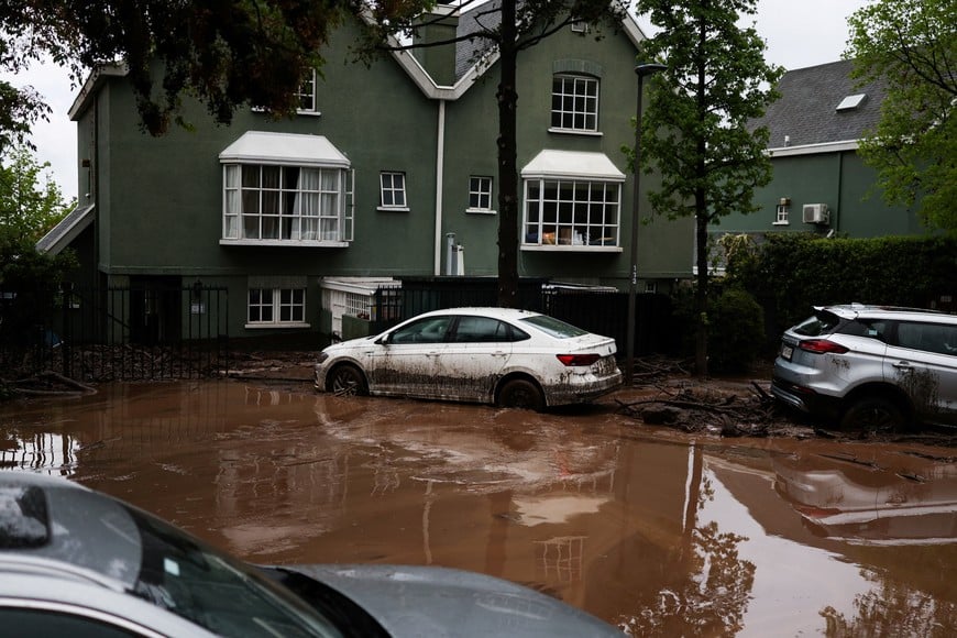 Vehicles parked amid mud after heavy rains triggered a mudslide in Santiago, Chile, October 8, 2026. REUTERS/Pablo Sanhueza