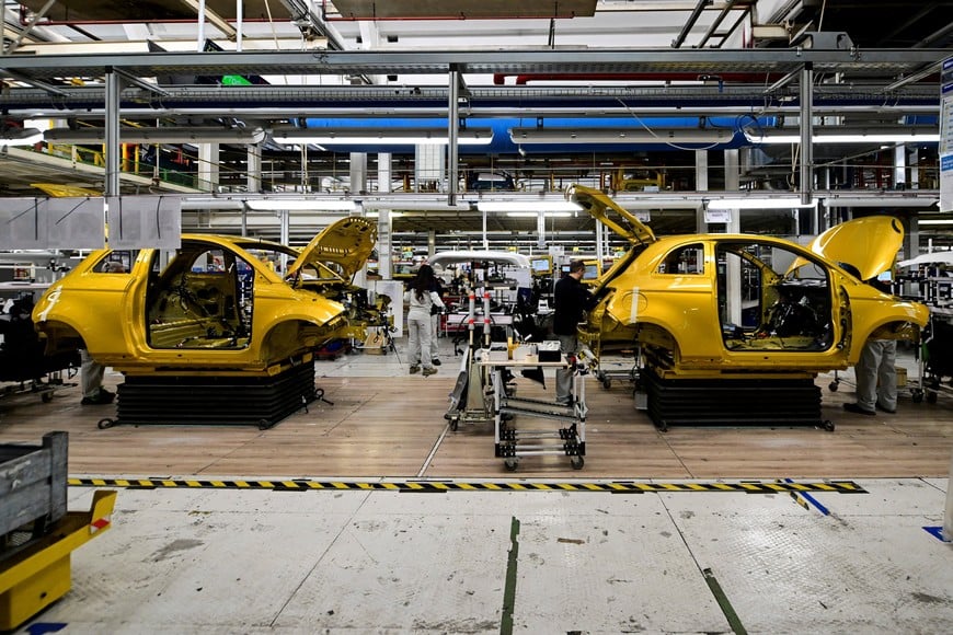Stellantis technicians work on the chassis of the new hybrid version of the Fiat 500 on the production line inside the Mirafiori plant in Turin, Italy, November 25, 2025. REUTERS/Daniele Mascolo
