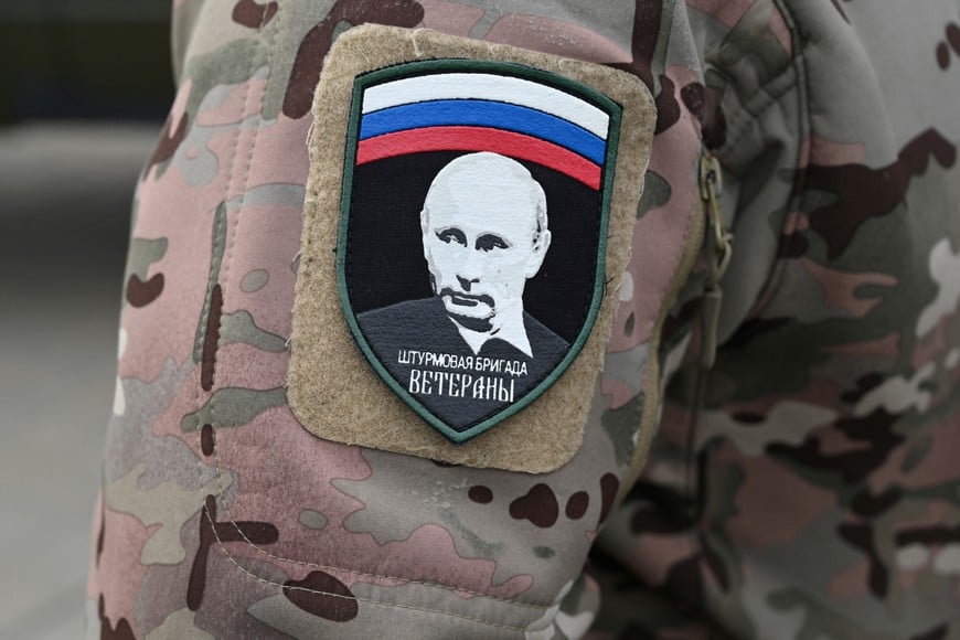 A Russian service member wears a patch depicting Russian President Vladimir Putin during a ceremony to receive new vehicles and military equipment handed over by the Russian movement "People's Front" for the military involved in Russia-Ukraine conflict, in Rostov-on-Don, Russia February 23, 2025. The patch reads: "Veterans assault brigade." REUTERS/Stringer