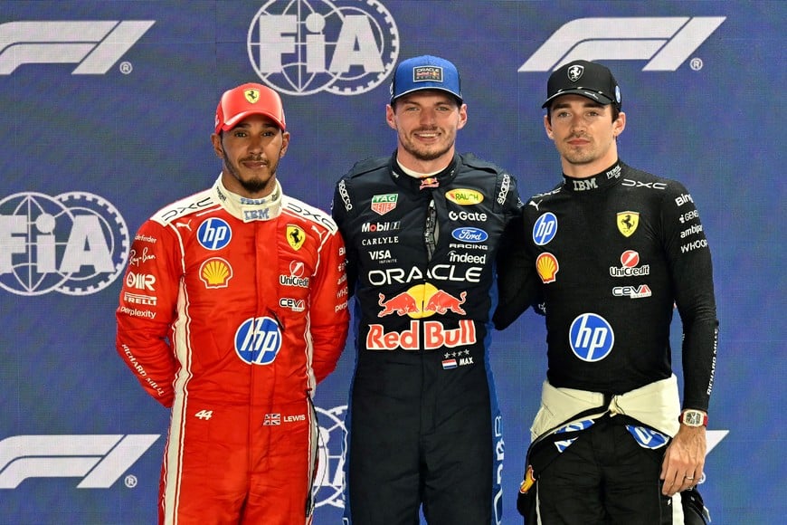 Formula One F1 - Singapore Grand Prix - Marina Bay Street Circuit, Singapore - October 10, 2026
Red Bull's Max Verstappen celebrates on the podium after qualifying in pole position with second placed Ferrari's Charles Leclerc and third placed Ferrari's Lewis Hamilton REUTERS/Caroline Chia