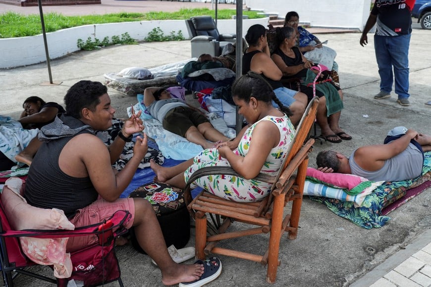 People gather outside their houses after an earthquake struck near Panama’s southern coast, in La Villa de los Santos, Panama, October 10, 2026. REUTERS/Enea Lebrun