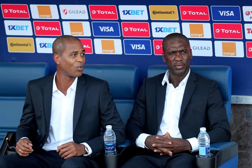 FILE PHOTO: Soccer Football - Africa Cup of Nations 2019 - Round of 16 - Nigeria v Cameroon - Alexandria Stadium, Alexandria, Egypt - July 6, 2019  Cameroon coach Clarence Seedorf and assistant coach Patrick Kluivert before the match      REUTERS/Suhaib Salem/File Photo