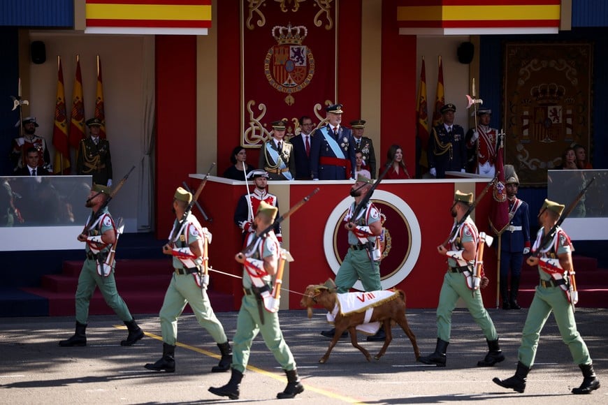 Spain's King Felipe, Queen Letizia, Princess Leonor, Princess Sofia and Spain's Prime Minister Pedro Sanchez watch members of the Spanish military walking with the traditional mascot called the Goat of the Spanish Legion during a military parade to mark the country's National Day, in Madrid, Spain, October 12, 2026. REUTERS/Alejandro Martinez Velez