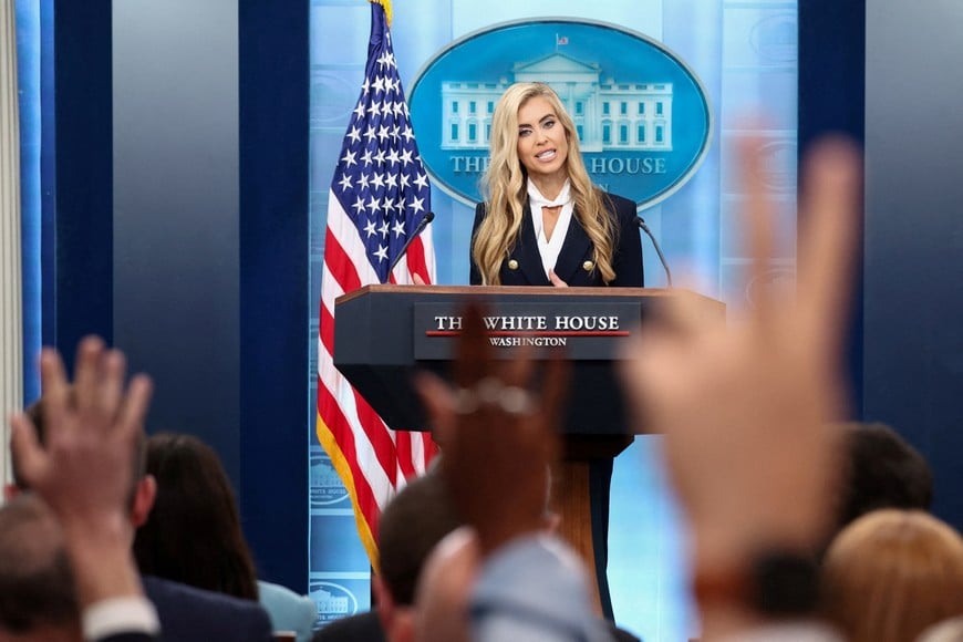 Reporters raise their hands to ask questions as the new White House Press Secretary Katie Zacharia holds her first press briefing at the White House in Washington, DC, US, October 13, 2026. REUTERS/Kevin Lamarque TPX IMAGES OF THE DAY