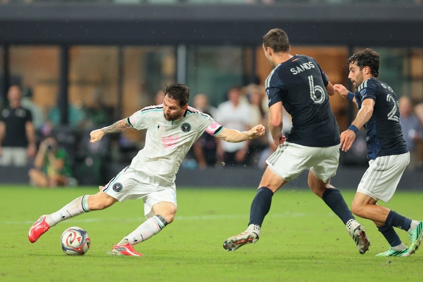 Oct 14, 2026; Miami, Florida, USA; Inter Miami CF forward Leo Messi (10) dribbles the ball against New York City midfielder James Sands (6) and defender Kevin O'Toole (22) during the second half at Nu Stadium. Mandatory Credit: Sam Navarro-Imagn Images